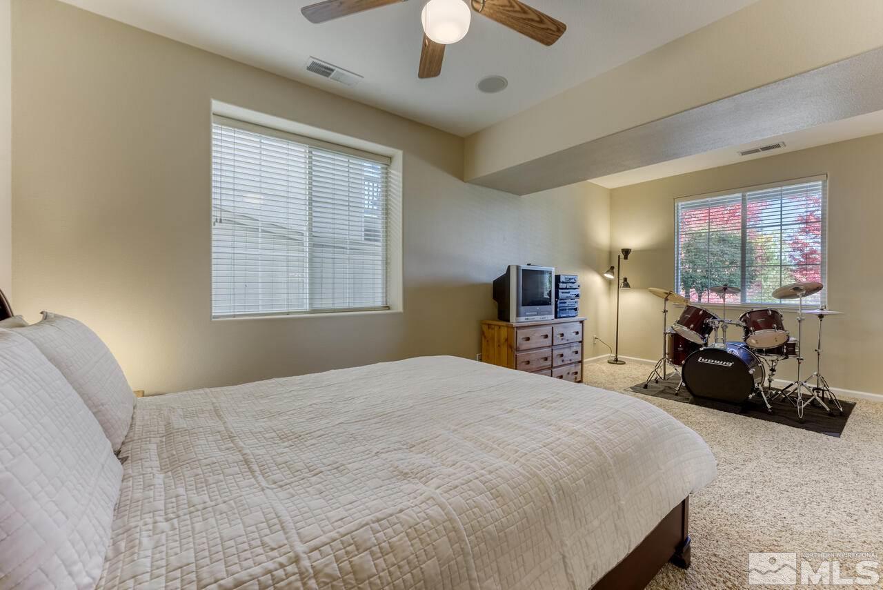 3755 Bridge Creek Court Reno, NV 89519 - Photo 30 of 40 a bedroom with a bed couch and large windows