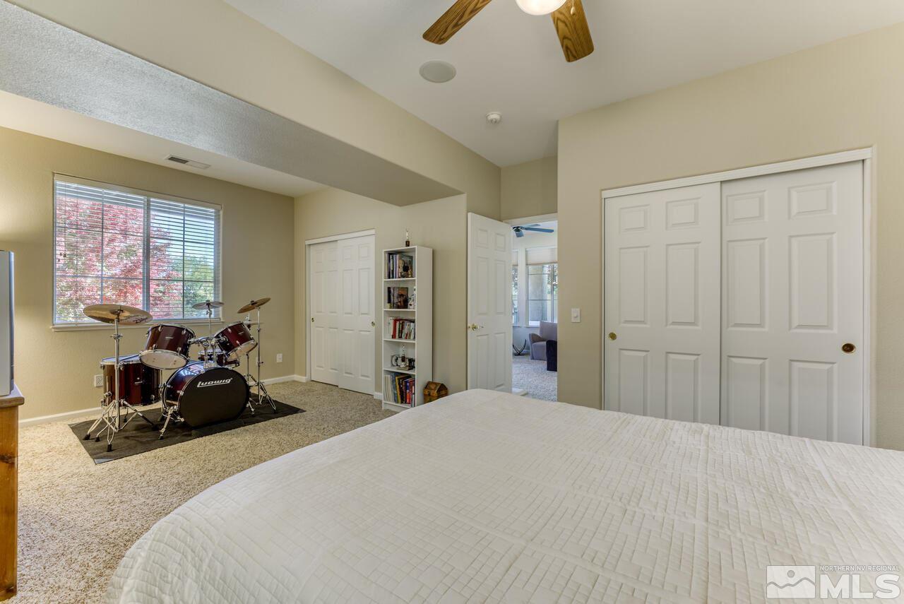 3755 Bridge Creek Court Reno, NV 89519 - Photo 31 of 40 a bedroom with a bed and a chandelier