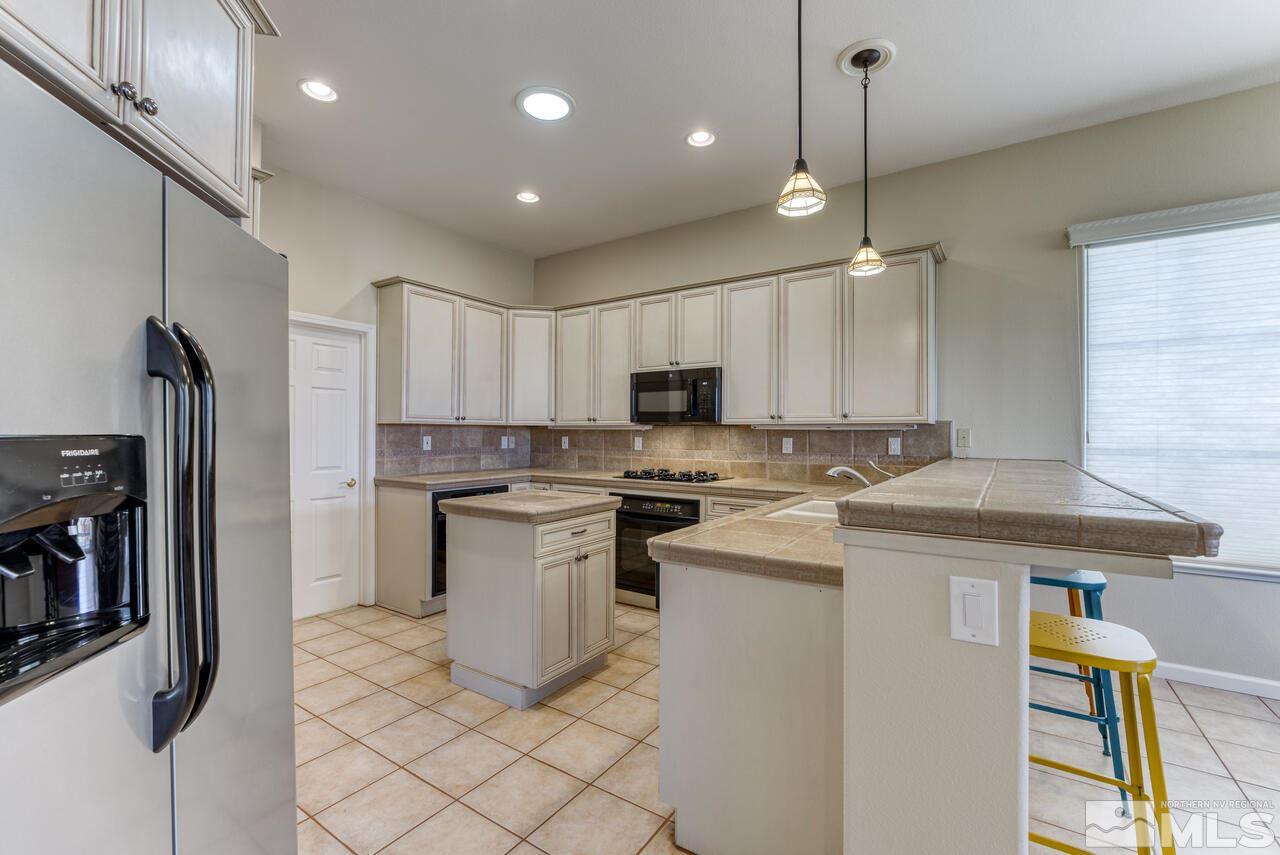 3755 Bridge Creek Court Reno, NV 89519 - Photo 4 of 40 a kitchen with a sink stainless steel appliances and cabinets