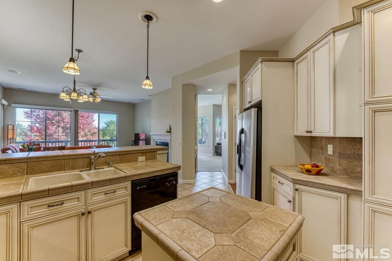 3755 Bridge Creek Court Reno, NV 89519 - Photo 6 of 40 a kitchen with stainless steel appliances granite countertop a sink refrigerator and cabinets