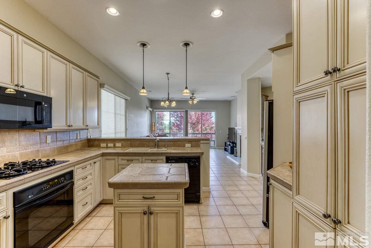 3755 Bridge Creek Court Reno, NV 89519 - Photo 7 of 40 a kitchen with stainless steel appliances granite countertop a stove a sink and a refrigerator