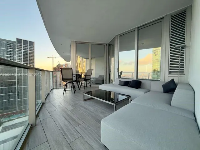 a view of a balcony with furniture