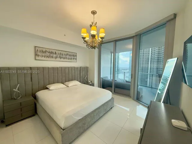 a bedroom with a bed and a television