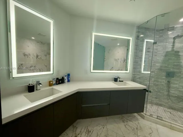 a bathroom with a bathtub and a shower