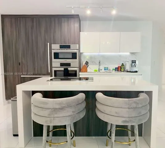 a kitchen with a table and chairs
