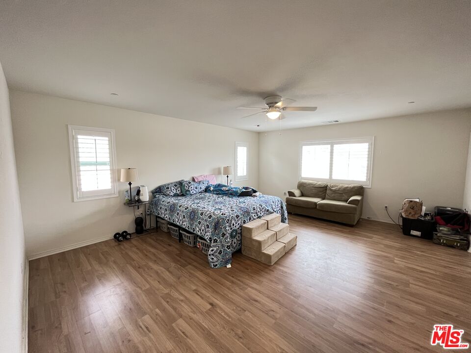 11785 Connell Road Riverside, CA 92505 - Photo 22 of 39 a bedroom with a bed a couch and dresser