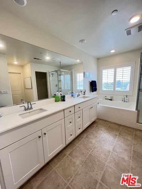11785 Connell Road Riverside, CA 92505 - Photo 24 of 39 a large bathroom with a double vanity sink mirror and window