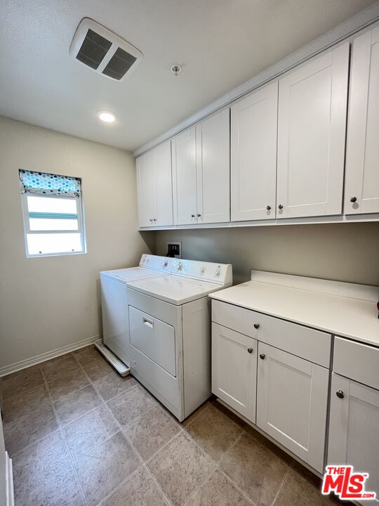 11785 Connell Road Riverside, CA 92505 - Photo 27 of 39 a utility room with cabinets washer and dryer