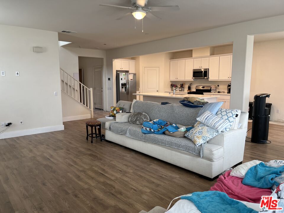 11785 Connell Road Riverside, CA 92505 - Photo 4 of 39 a living room with furniture and a kitchen view
