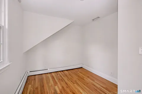 a view of room with wooden floor