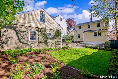 a backyard of a house with table and chairs