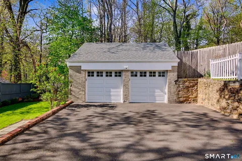 a view of a house with a yard and garage
