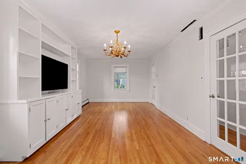 wooden floor in an empty room with a window and wooden floor