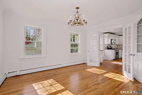 a view of a room with wooden floor and windows