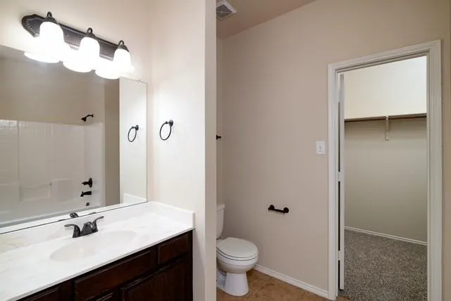 a bathroom with a sink a toilet a shower and a mirror