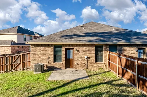 a view of a house with backyard porch and furniture