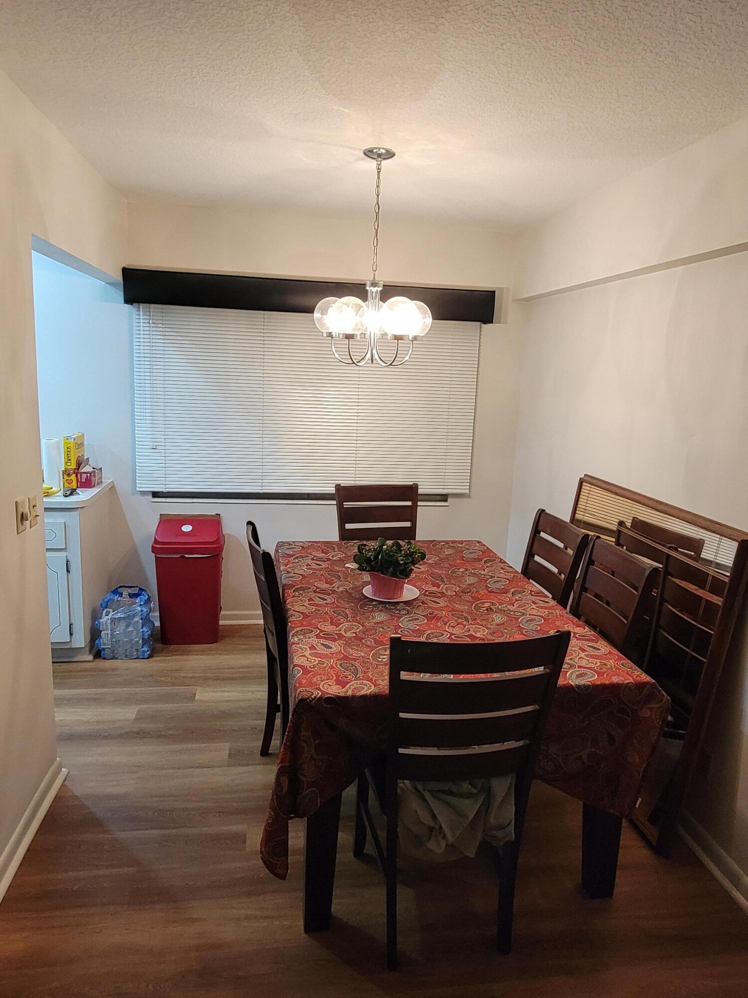 326 Fanshaw Drive, Unit H Boca Raton, FL 33434 - Photo 3 of 10 a view of a dining room with furniture and wooden floor