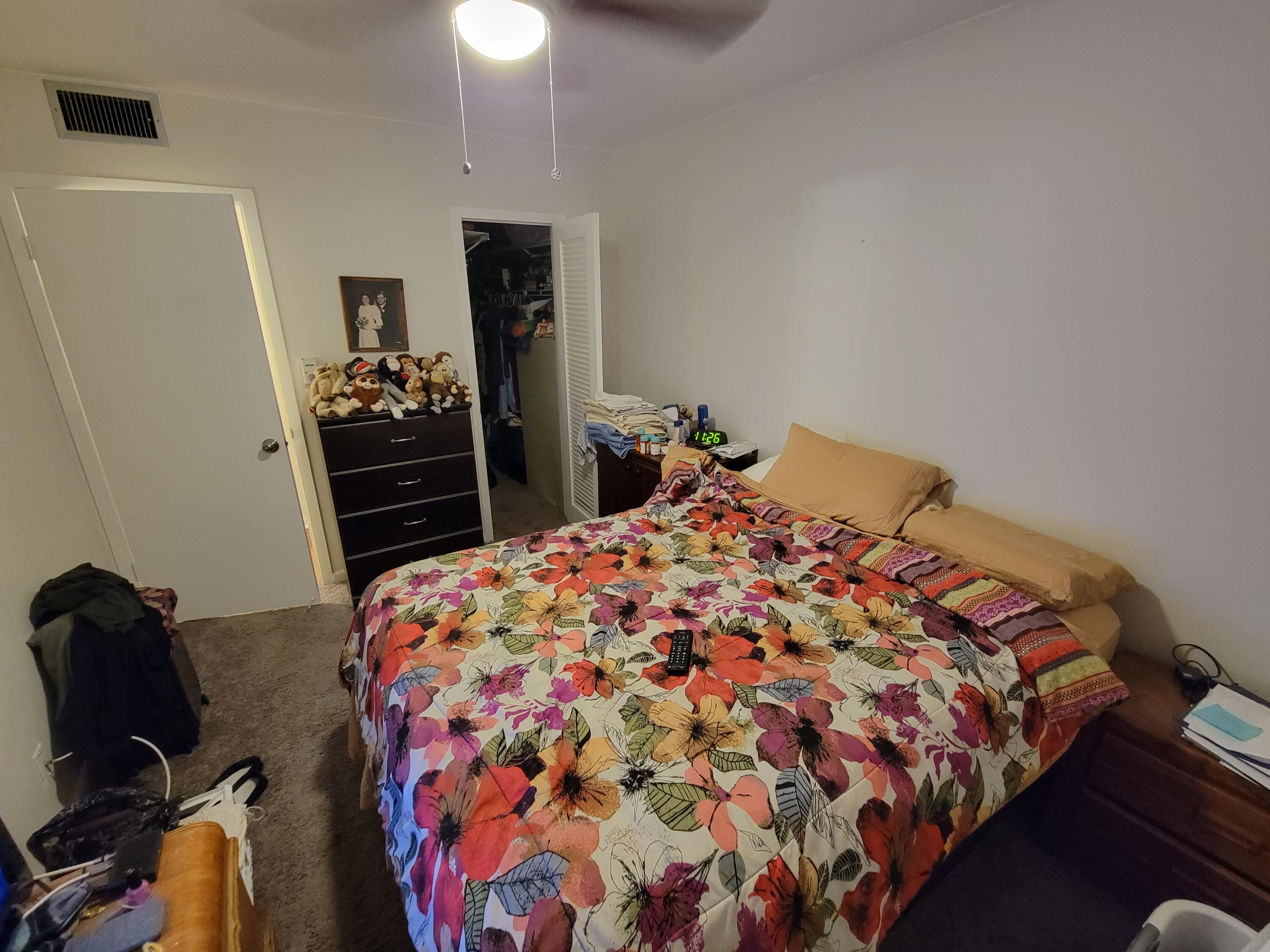 326 Fanshaw Drive, Unit H Boca Raton, FL 33434 - Photo 7 of 10 a bedroom with a bed and a dresser