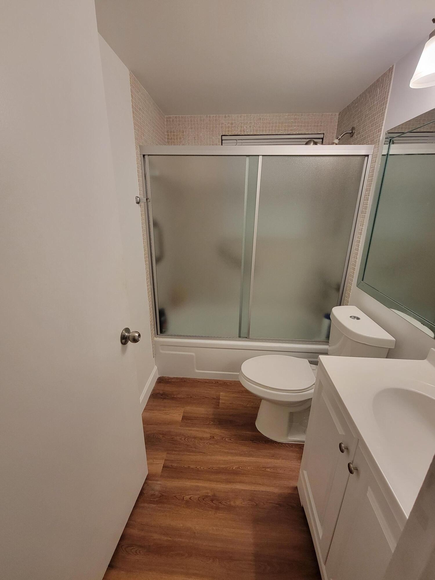 326 Fanshaw Drive, Unit H Boca Raton, FL 33434 - Photo 9 of 10 a bathroom with a toilet and a shower