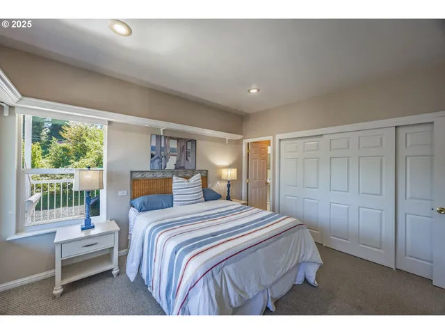 a bedroom with a large bed and a window