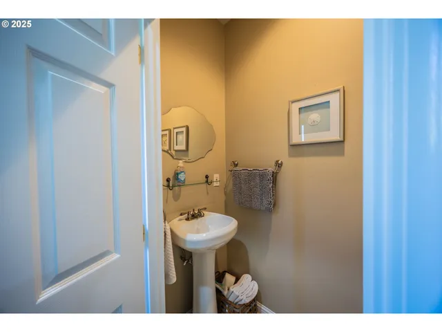 a bathroom with a sink mirror and toilet