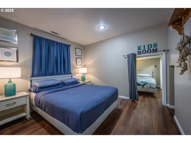 a bedroom with a bed and a large window