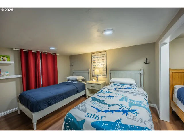 a bedroom with two beds and a dresser