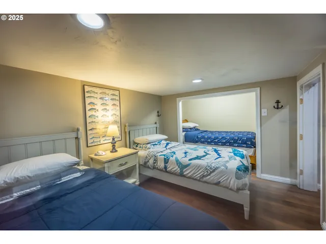 a bedroom with a bed window and a night stand