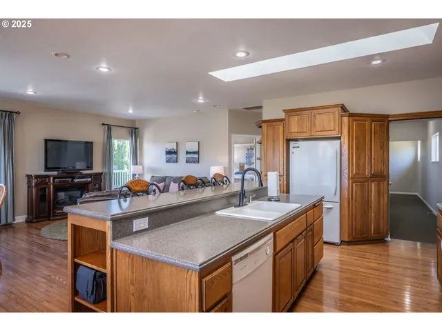 a view of kitchen island refrigerator sink dining table and chairs