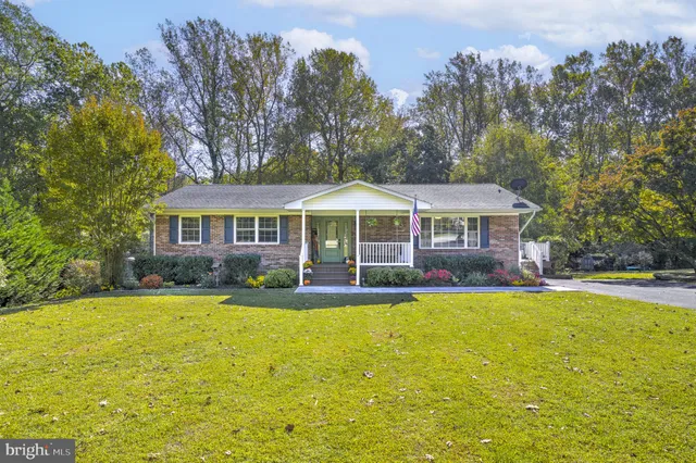 a front view of a house with swimming pool having outdoor seating