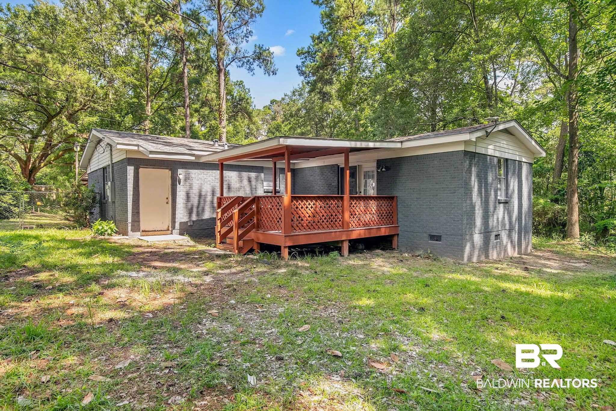 3304 Armond Drive Mobile, AL 36605 - Photo 50 of 62 Back of house featuring crawl space, brick siding, a yard, and a wooden deck