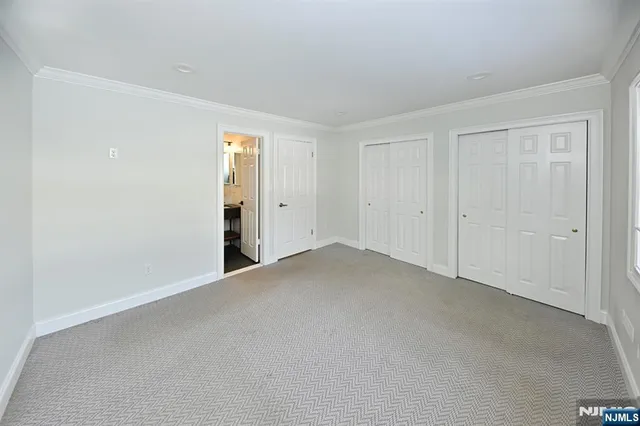 a view of an empty room and closet area