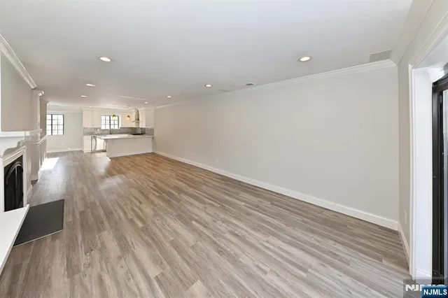 a view of a kitchen with wooden floor and a kitchen