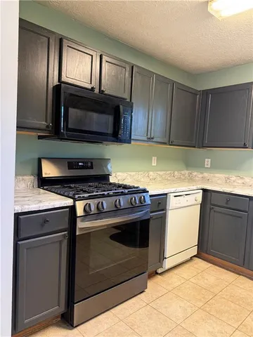 a kitchen with a refrigerator and a sink