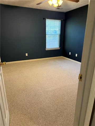 an empty room with windows and closet