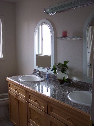 1425 Sioux Trail Reno, NV 89521 - Photo 3 of 4 a bathroom with a granite countertop sink a mirror and next to a window