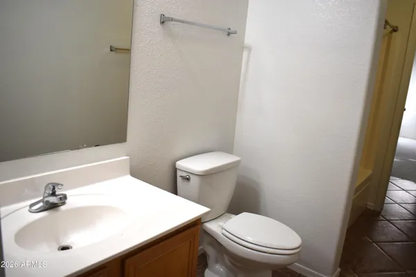 a white toilet sitting next to a bathroom sink