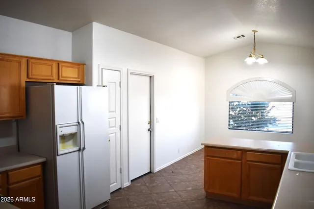 a kitchen with stainless steel appliances granite countertop a sink a stove and a refrigerator