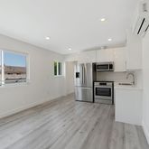 a kitchen with stainless steel appliances a refrigerator and a stove top oven