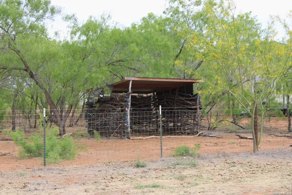 a view of a barn house and a yard with wooden fence