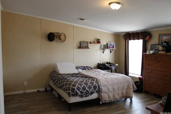 a bedroom with a bed and a dresser