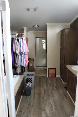 a view of walk in closet with clothes