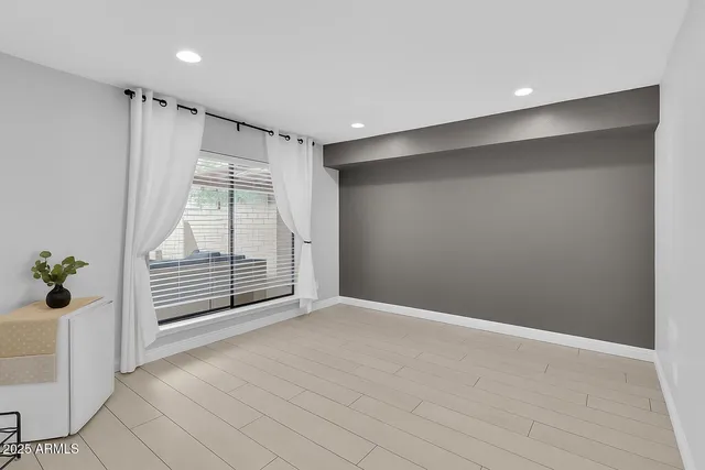 a bedroom with a large bed and a fireplace