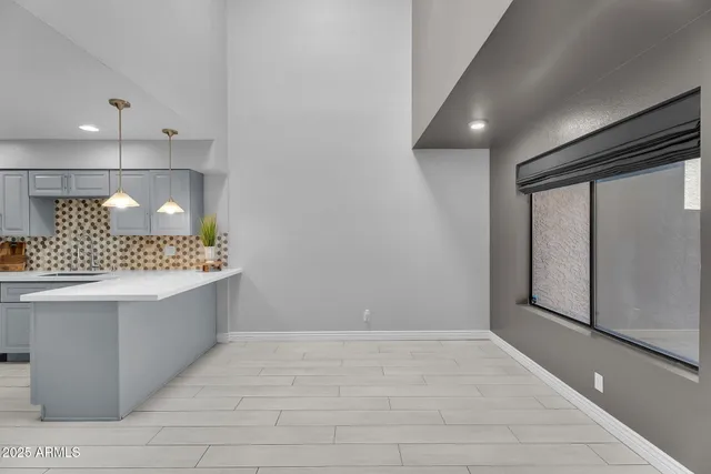 a view of a dining room with furniture and a potted plant