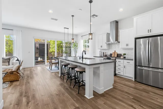 a large white kitchen with a double vanity sink and a stove