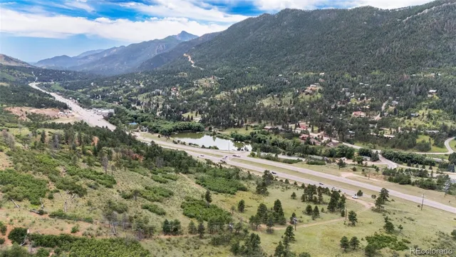 a view of a field with mountains in the background