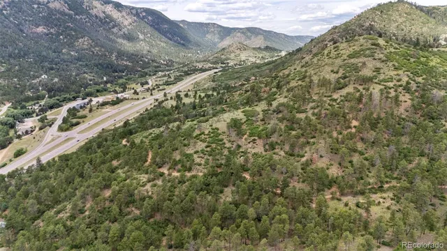 a view of a large building with mountains in the background
