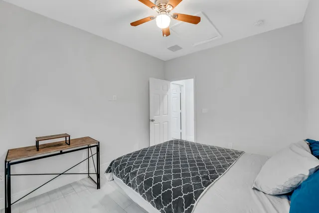 a bedroom with bed and a window