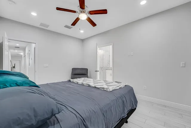 a bedroom with a large bed and a chandelier