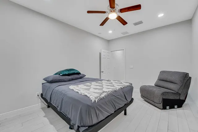 a bedroom with a bed and a ceiling fan